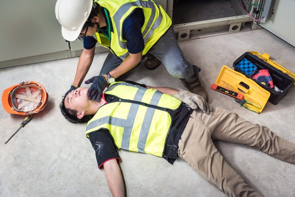 a construction worker helping his injured co-worker