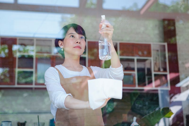 a woman cleaning the glass