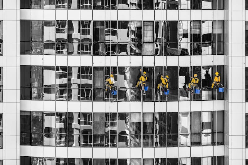 commercial cleaners cleaning the windows of a building